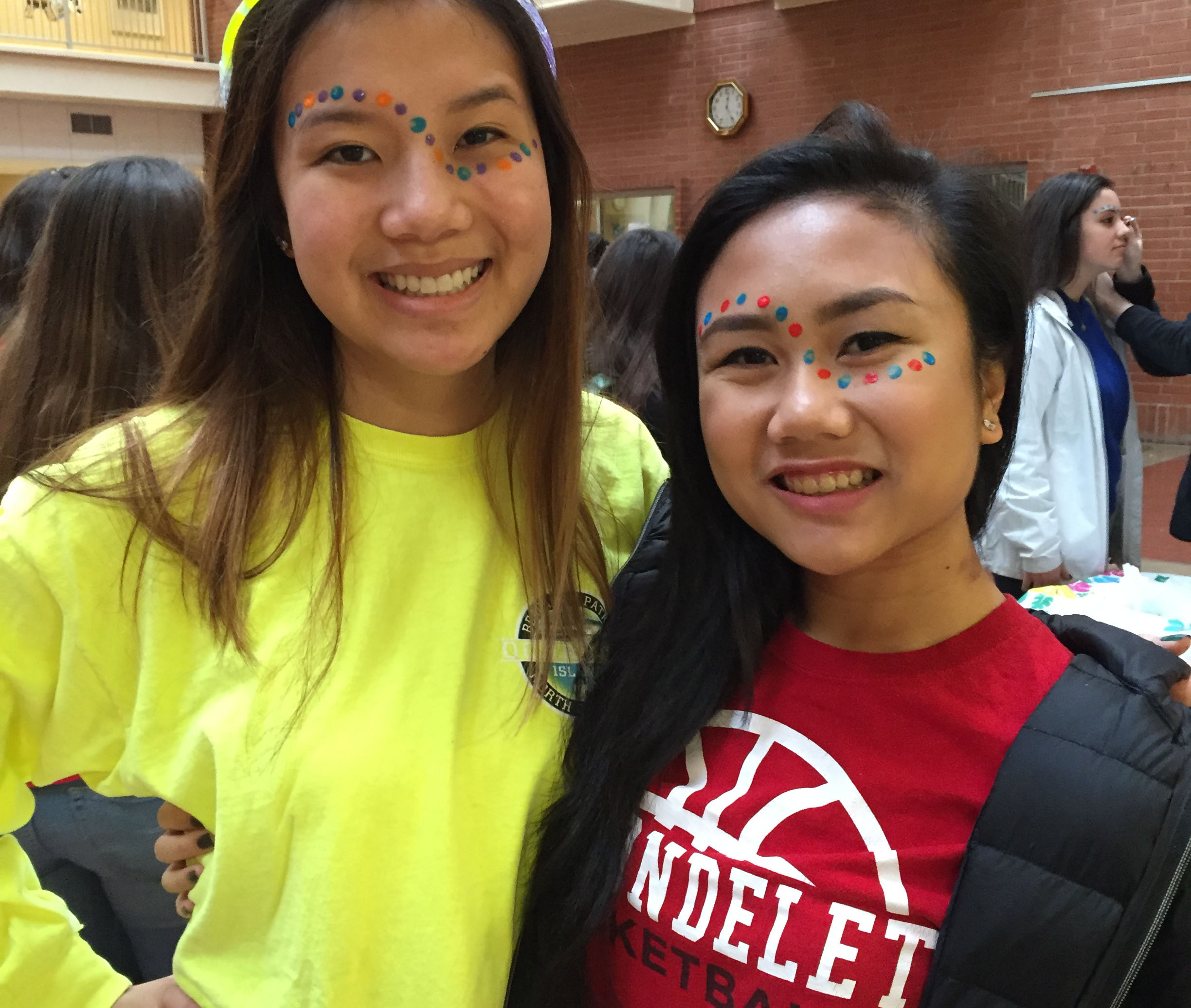 Two smiling Carondelet students with face paint